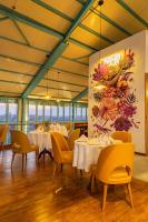 a restaurant with tables and chairs and a painting on the wall at Mhendo Hotel & Studio Suites in Kathmandu