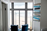 a room with two chairs and a view of the beach at The Pearl Suite by Margate Suites in Margate