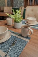 una mesa de madera con platos y tazas y un tenedor en Centenario Hotel Boutique, en Quetzaltenango