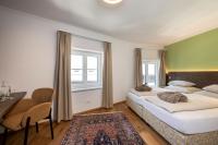 A bed or beds in a room at Kirchenwirt