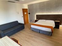 A bed or beds in a room at Hotel Sirena - B&B