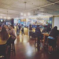 a group of people sitting at tables in a bar at Albion Hotel in Auckland