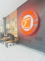 a group of people sitting at tables in front of a restaurant at We Vibe, 81 Newport Blvd across NAIA 3 in Manila