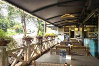 ein Restaurant mit Tischen und Stühlen und einem Zaun in der Unterkunft Basilica Resort - Where Luxury Redefines in Mahabaleshwar