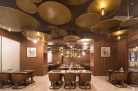 a large dining room with tables and chandeliers at 威海卫大厦 Weihaiwei Hotel in Weihai