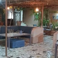 a dining room with a table and a couch at "Par 4 chemins" Atypical Stopover in Nouakchott