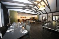 Un comedor con mesas largas y sillas. en Mahogany Inn and Distillery, en Mahogany Creek