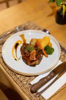 a plate of food with meat and vegetables on a table at Mologa River Lodge in Rust de Winter