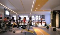 einen Fitnessraum mit Laufbändern und Personen im Hintergrund in der Unterkunft Otonomus Hotel Las Vegas in Las Vegas