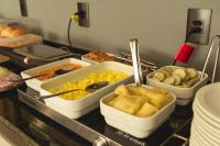 un bancone con diversi vassoi di cibo sopra di Hotel Caminhos da Oiticica a Jucurutu