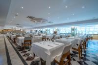 a dining room with white tables and chairs at Hotel Aqua in Marmaris
