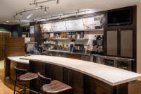 a bar in a restaurant with two stools at Courtyard by Marriott Boulder Broomfield in Louisville