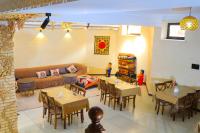 een woonkamer met tafels en stoelen en een bank bij ELANI Hotel in Samarkand