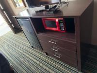 eine rote Mikrowelle auf einem Holzschrank in der Unterkunft labh inc Motel in Norfolk