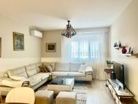 a living room with a couch and a tv at Adra&#39;s apartment in Shkodër