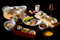 a table with plates of food and bowls of food at Wataya Besso in Ureshino