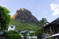 a mountain in the distance with houses and trees at Residence Ma Vie Là Ltee in Le Morne