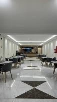 a dining room with tables and chairs in a restaurant at فندق مروج الماس in Abha