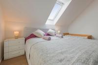 a bedroom with a large white bed with two lamps at Guest House KRISTI in Tuchoměřice