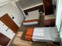 A bed or beds in a room at Hotel Sirena - B&B