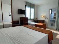 A bed or beds in a room at Hotel Sirena - B&B
