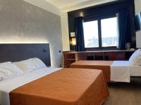 A bed or beds in a room at Hotel Sirena - B&B