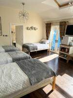 a bedroom with two beds and a room with a window at Gracefield in Artane