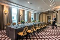 a man standing in front of a long table in a room at The Gainsborough Bath Spa - Small Luxury Hotels of the World in Bath