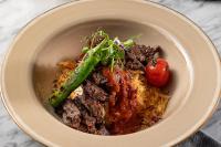 een bord met vlees en aardbeien bij Stayso The House Hotel in Istanbul