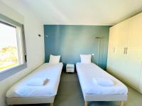 Łóżko lub łóżka w pokoju w obiekcie PGH N9- Vue Mer, 100m de la Plage & Parking Privé
