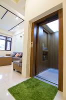 a living room with a door and a green rug at 充電樁 羅東木村電梯民宿Luodong Tree BnB 雲朵朵二館 免費洗衣機 烘衣機 星巴克咖啡豆 國旅卡特約店 in Luodong