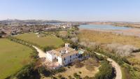 an aerial view of a house on a hill next to a river at Hacienda el Santiscal in Arcos de la Frontera