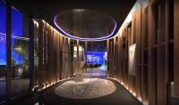 a hallway of a building with lights on the walls at Swissôtel Living Jakarta Mega Kuningan in Jakarta