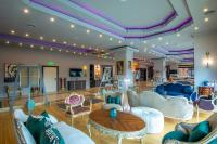 a lobby with white furniture and purple ceilings at Phoenicia Express Hotel in Bucharest