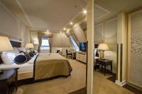 a hotel room with a large bed and a desk at Wilson Palace by LOFT in Bratislava