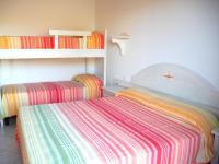 A bed or beds in a room at Baia Fiorita