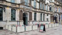 a line of parking meters in front of a building at The Royal Hotel Cardiff in Cardiff