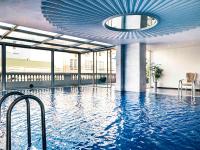 a pool in a building with a blue ceiling at Hotel de l'Opera Hanoi - MGallery in Hanoi