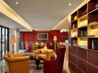 a living room with couches chairs and a table at Hotel de l'Opera Hanoi - MGallery in Hanoi