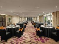 a banquet hall with black tables and chairs and a screen at Hotel de l'Opera Hanoi - MGallery in Hanoi