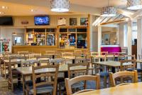 莫克姆8 berth Caravan的一家有桌椅和酒吧的餐厅