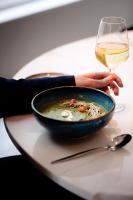 una persona sosteniendo un tazón de sopa y una copa de vino en Pillows City Hotel Brussels Centre, en Bruselas