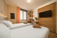 Televízia a/alebo spoločenská miestnosť v ubytovaní Hotel Oasi Verde