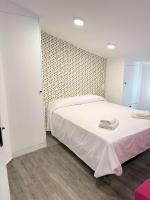 Postel nebo postele na pokoji v ubytování Apartamentos Carmela
