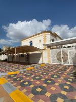 a building with a tile floor in front of a building at International Abu Dhabi Hostel in Abu Dhabi