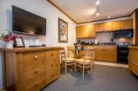 a kitchen with a table and a dining room at Kandahar Lodge at Whitefish Mountain Resort in Whitefish