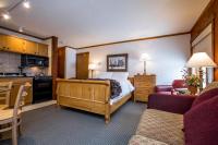 a hotel room with a bed and a kitchen at Kandahar Lodge at Whitefish Mountain Resort in Whitefish