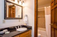 a bathroom with a sink and a toilet and a mirror at Kandahar Lodge at Whitefish Mountain Resort in Whitefish