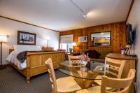 a hotel room with a bed and a dining room at Kandahar Lodge at Whitefish Mountain Resort in Whitefish