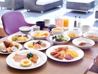 a table with plates of breakfast food on it at Miyako Hotel Kyoto Hachijo in Kyoto
